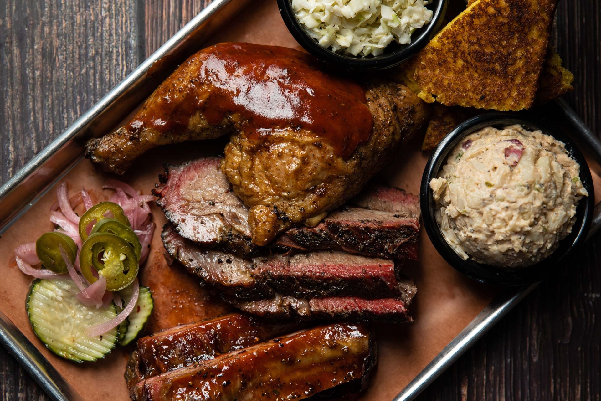 plated three meat meal with chicken, brisket and ribs